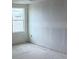 This bedroom with drywall and concrete floors has a window providing natural light at 22117 Amberbush Court, Mount Dora, FL 32757