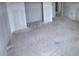 A spacious living room with unfinished concrete floors and bare drywall, waiting for design and personalization at 22117 Amberbush Court, Mount Dora, FL 32757