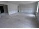 A spacious living room with unfinished concrete floors and bare drywall, waiting for design and personalization at 22117 Amberbush Court, Mount Dora, FL 32757