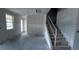 Open-concept living room with stairs and natural light, perfect for gathering at 22117 Amberbush Court, Mount Dora, FL 32757