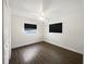 Bedroom with hardwood floors, two windows, and a ceiling fan at 224 Briar Cliff Dr, Longwood, FL 32779
