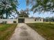 Charming home with a driveway, lawn, and mature trees at 224 Briar Cliff Dr, Longwood, FL 32779