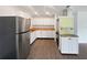 Bright kitchen with stainless fridge, white cabinets, wood countertop, and modern fixtures at 224 Briar Cliff Dr, Longwood, FL 32779