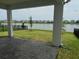 Covered back patio overlooks a tranquil lake view, enhancing the outdoor living experience at 2620 Blowing Breeze Ave, Kissimmee, FL 34744