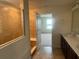 This bathroom features a tiled shower and a double vanity with ample counter space at 2620 Blowing Breeze Ave, Kissimmee, FL 34744