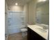 Bathroom featuring a shower-tub combo, a single sink vanity with dark cabinets, and tile floors at 2620 Blowing Breeze Ave, Kissimmee, FL 34744