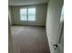The bedroom boasts natural light from two windows overlooking the community at 2620 Blowing Breeze Ave, Kissimmee, FL 34744