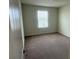Neutral bedroom with carpet, a window, and light walls at 2620 Blowing Breeze Ave, Kissimmee, FL 34744