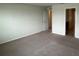 A spacious bedroom features neutral carpeting and paint, with doorways leading to other rooms at 2620 Blowing Breeze Ave, Kissimmee, FL 34744