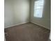 Neutral bedroom with carpet, a large window for natural light, and ample space at 2620 Blowing Breeze Ave, Kissimmee, FL 34744