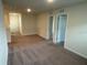 Upstairs bonus room features carpet and neutral walls at 2620 Blowing Breeze Ave, Kissimmee, FL 34744