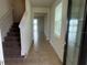 Inviting foyer with tile flooring, staircase, and natural light creating a warm entry at 2620 Blowing Breeze Ave, Kissimmee, FL 34744