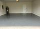 Spacious two car garage with epoxy flooring and an insulated garage door at 2620 Blowing Breeze Ave, Kissimmee, FL 34744