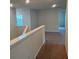 The upstairs hallway boasts carpet floors and is lit with recessed lighting at 2620 Blowing Breeze Ave, Kissimmee, FL 34744