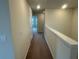 A brightly lit hallway features neutral walls and carpeting leading to various rooms in the home at 2620 Blowing Breeze Ave, Kissimmee, FL 34744