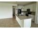 Modern kitchen with stainless steel appliances, granite countertops, recessed lighting, and open to the living area at 2620 Blowing Breeze Ave, Kissimmee, FL 34744