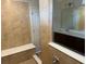 A tile shower features a built in bench and a glass enclosure at 2620 Blowing Breeze Ave, Kissimmee, FL 34744