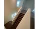 Carpeted staircase with a window providing natural light illuminates the home's interior at 2620 Blowing Breeze Ave, Kissimmee, FL 34744