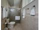 Bathroom featuring tiled walls and a glass door shower at 2673 Dixie Ln, Kissimmee, FL 34744
