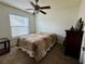 Bedroom with a ceiling fan and a side table at 2673 Dixie Ln, Kissimmee, FL 34744