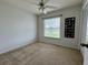 Bedroom with a closet, window, and carpet flooring at 2673 Dixie Ln, Kissimmee, FL 34744