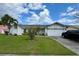 Charming single-story home with a well-maintained lawn, mature landscaping and a two-car garage at 2673 Dixie Ln, Kissimmee, FL 34744