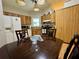 A kitchen and dining area featuring wood cabinetry and an adjacent dining table at 2673 Dixie Ln, Kissimmee, FL 34744
