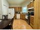 Well-appointed kitchen with classic cabinetry, tile flooring, and stainless steel appliances at 2673 Dixie Ln, Kissimmee, FL 34744