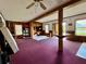 Living room with a bar, shelving, and a ceiling fan at 2673 Dixie Ln, Kissimmee, FL 34744