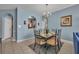 Dining area featuring blue walls and modern chandelier at 2781 Almaton Loop # 105, Kissimmee, FL 34747