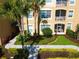 Exterior view of an apartment building with landscaping at 2781 Almaton Loop # 105, Kissimmee, FL 34747