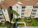 An aerial of the apartment complex featuring palm trees and manicured grounds at 2781 Almaton Loop # 105, Kissimmee, FL 34747