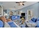 Bright living room featuring tile flooring, comfortable blue couches, and a glass coffee table with a floral area rug at 2781 Almaton Loop # 105, Kissimmee, FL 34747