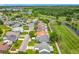 Community aerial view showcasing homes along a golf course with tree-lined streets at 2885 Autumn Green Dr, Orlando, FL 32822