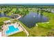 Scenic aerial view of the pool and clubhouse with lush landscaping and golf course at 2885 Autumn Green Dr, Orlando, FL 32822