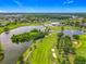 Stunning aerial view of the golf course community, complete with lakes, pools, and lush greenery at 2885 Autumn Green Dr, Orlando, FL 32822