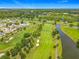 Panoramic aerial view of the golf course, with lake and community homes in the distance at 2885 Autumn Green Dr, Orlando, FL 32822