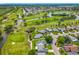 Community aerial view showcasing homes along a golf course with beautiful waterways at 2885 Autumn Green Dr, Orlando, FL 32822