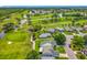 Scenic aerial view of community homes alongside the beautiful golf course and waterways at 2885 Autumn Green Dr, Orlando, FL 32822