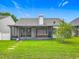 Charming home with a screened patio and lush lawn, perfect for outdoor living at 2885 Autumn Green Dr, Orlando, FL 32822