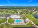 Aerial view of the community clubhouse with pool, golf course, and beautiful landscaping at 2885 Autumn Green Dr, Orlando, FL 32822