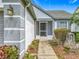 Inviting front entrance with a screened in porch and beautiful landscaping at 2885 Autumn Green Dr, Orlando, FL 32822