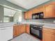 Kitchen with oak cabinets, a window, and appliances at 2885 Autumn Green Dr, Orlando, FL 32822
