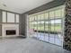 Living room featuring a fireplace, carpet, and a sliding glass door to the patio at 2885 Autumn Green Dr, Orlando, FL 32822
