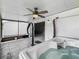 Covered outdoor space includes a hot tub, ceiling fan and view of backyard at 2885 Autumn Green Dr, Orlando, FL 32822