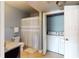 Full bathroom with tile floors, shower/tub combo, and in-unit washer and dryer at 300 E South St # 6003, Orlando, FL 32801