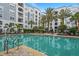 Beautiful community pool surrounded by palm trees and lounge chairs at 300 E South St # 6003, Orlando, FL 32801