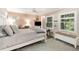 Cozy bedroom featuring a comfortable bed, a window with shutter blinds and a small work space, perfect for relaxation at 3104 Harrison Ave # E-30, Orlando, FL 32804