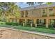 Charming multi-level condo showcases manicured landscaping with lush, green hedges and a well-maintained lawn at 3104 Harrison Ave # E-30, Orlando, FL 32804