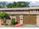 Charming townhouse featuring a well-maintained exterior with a private entrance, brick accents, and attached garage at 3104 Harrison Ave # E-30, Orlando, FL 32804